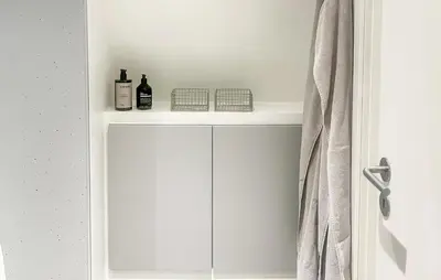 a white cabinet with bottles on it in a bathroom at Awesome Home In Farsø With Wifi in Farsø