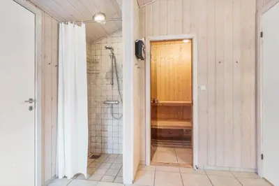 a bathroom with a walk in shower and a shower stall at BL1143-Blokhus-Engen-1 in Blokhus