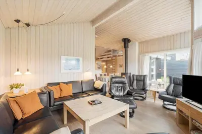 a living room with a couch and a table at BL1143-Blokhus-Engen-1 in Blokhus