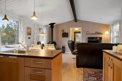 a kitchen with a sink and a living room at 1371-Thisted-Havtornvej-1 in Nørre Vorupør