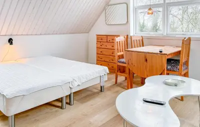 a bedroom with a bed and a desk and a table at Stunning Apartment In Roslev With Wifi in Roslev