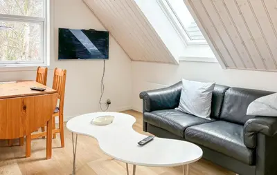 a living room with a couch and a table at Stunning Apartment In Roslev With Wifi in Roslev