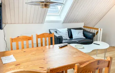 a living room with a table and a couch at Stunning Apartment In Roslev With Wifi in Roslev