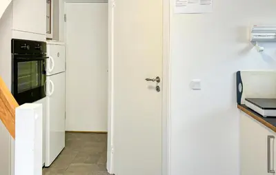 a kitchen with a white door and a refrigerator at Stunning Apartment In Roslev With Wifi in Roslev