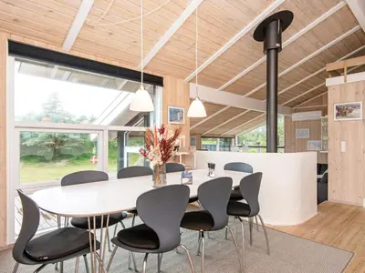 a dining room with a white table and chairs at 4 star holiday home in Løkken in Løkken