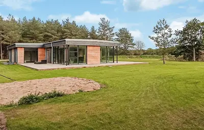 a house in a field with a green yard at Nice Home In Skals With Wifi in Skals