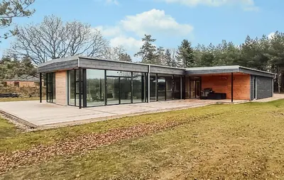 a large house with glass doors on a field at Nice Home In Skals With Wifi in Skals