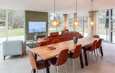 a dining room with a wooden table and chairs at Nice Home In Skals With Wifi in Skals