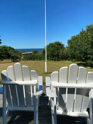 a group of white chairs sitting around a table at Cozy Holiday Home With Fjord Views On Fur in Fur
