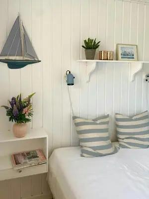 a bedroom with a bed with two pillows and a lamp at Cozy Holiday Home With Fjord Views On Fur in Fur