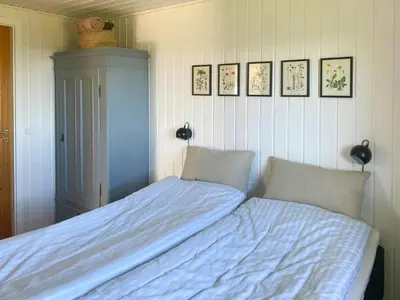 a bedroom with a bed and two pillows at Cozy Holiday Home With Fjord Views On Fur in Fur