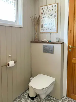 a bathroom with a white toilet and a window at Cozy Holiday Home With Fjord Views On Fur in Fur