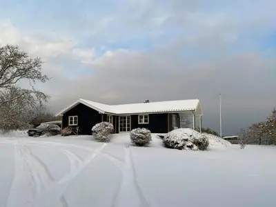 a house covered in snow in front at Cozy Holiday Home With Fjord Views On Fur in Fur