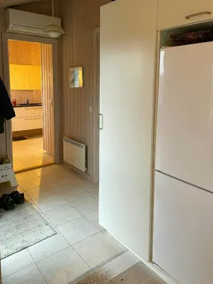 a kitchen with a white refrigerator in a room at Summer House With Views Over Jammerbugt in Saltum
