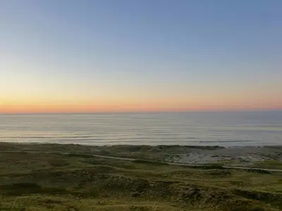 a view of the ocean at sunset at Restored Fisherman's House On Cliff In Thy in Hanstholm