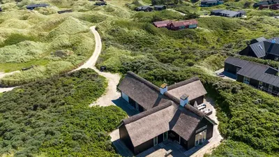 an aerial view of a house on a hill at Thatched House At First Dune Row In Blokhus in Blokhus