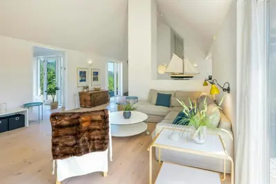 a living room with a couch and a table at Thatched House At First Dune Row In Blokhus in Blokhus