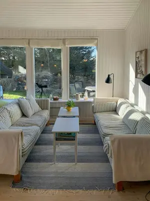 a living room with two couches and a coffee table at Holiday Home By The North Sea Dunes In Rødhus in Pandrup