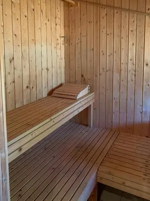 a wooden sauna with two wooden benches in it at Holiday Home By The North Sea Dunes In Rødhus in Pandrup