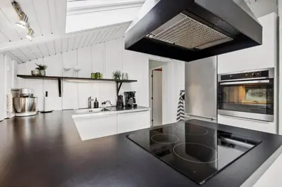 a kitchen with a black and white counter top at BL1155-Blokhus-Berberisvej-74 in Blokhus