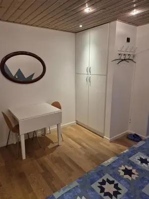a room with a white table and a mirror at Marias house i Agger in Vestervig