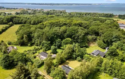 an aerial view of a house with trees and the water at Nice Home In Farsø With House A Panoramic View in Farsø