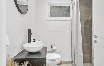 a white bathroom with a sink and a toilet at Nice Home In Farsø With House A Panoramic View in Farsø