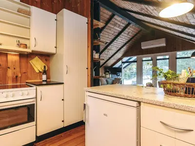 a kitchen with white cabinets and a counter top at Holiday home near fishing lake in Fjerritslev