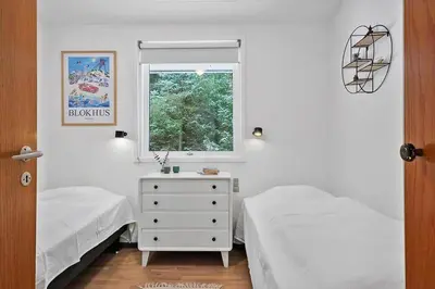 a bedroom with two beds and a window at BL1154-Blokhus-Kornblomstvej-22 in Blokhus