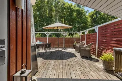 a patio with a table and an umbrella at JB381-Fjerritslev-Ahornvej-65