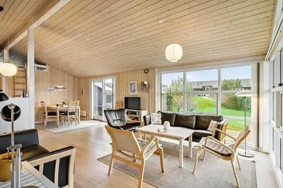 a living room with a couch and a table and chairs at JB406-Fjerritslev-Aspevej-68 in Fjerritslev