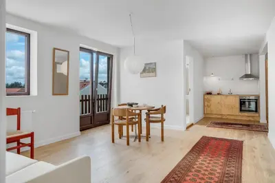 a kitchen and dining room with a table and chairs at Søndergade 21, Lejl 3 in Løkken