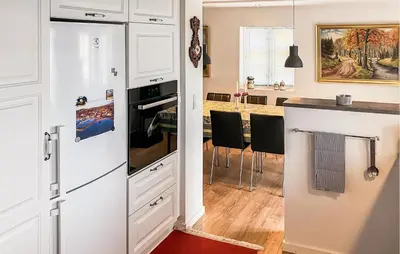 a kitchen with white cabinets and a white refrigerator at Nice Home In Løgstrup With Wifi in Løgstrup