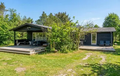 a small cabin with a deck and a house at Awesome Home In Erslev With Wifi in Erslev