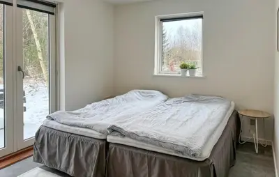 an unmade bed in a room with a window at Awesome Home In Erslev With Wifi in Erslev