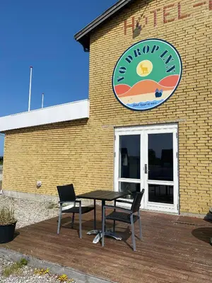 a table and chairs in front of a restaurant at VØ Budget Drop Inn in Thisted