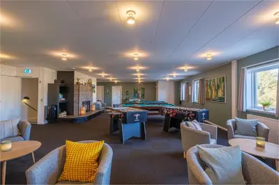 a room with couches tables and a pool table at Feriecenter Slettestrand in Fjerritslev