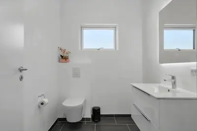 a white bathroom with a sink and a toilet at JB376-Fjerritslev-Egevej-14