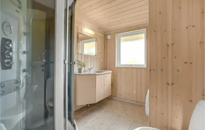 a bathroom with a shower and a sink at Holiday Home Hurup Thy With A Fireplace 06 in Heltborg