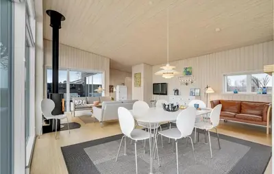 a dining room and living room with a table and chairs at Holiday Home Roslev With A Fireplace 01 in Roslev