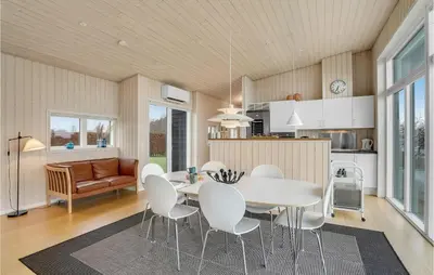 a kitchen and dining room with a table and chairs at Holiday Home Roslev With A Fireplace 01 in Roslev