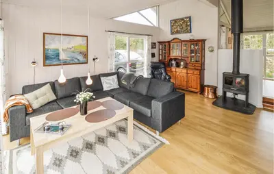 a living room with a couch and a table at Holiday Home Brovst With A Fireplace 03 in Brovst