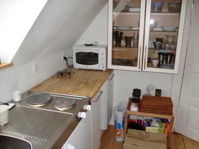 a small kitchen with a stove and a microwave at Klosterpensionen Annex in Viborg