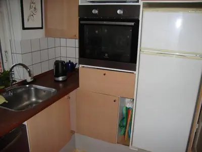 a kitchen with a white refrigerator and a sink at Klosterpensionen Annex in Viborg