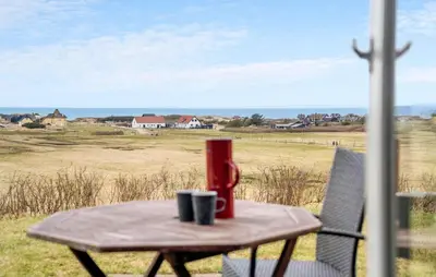 a table with two coffee mugs on top of it at Holiday Home Blokhus With Fireplace 05 in Blokhus
