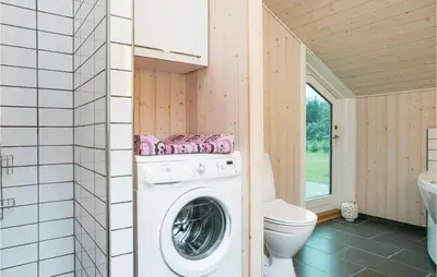 a washing machine in a bathroom with a toilet at Holiday Home Pandrup 07 in Pandrup