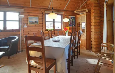 a dining room with a white table and chairs at Holiday Home Vinderup With Fireplace 07 in Vinderup
