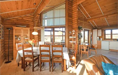 a dining room with a table and chairs at Holiday Home Vinderup With Fireplace 07 in Vinderup