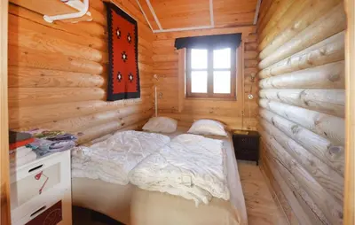 a bedroom with a bed in a log cabin at Holiday Home Vinderup With Fireplace 07 in Vinderup