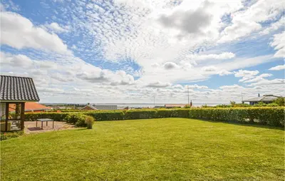 a large yard with a view of the ocean at Holiday Home Vinderup With Fireplace 07 in Vinderup